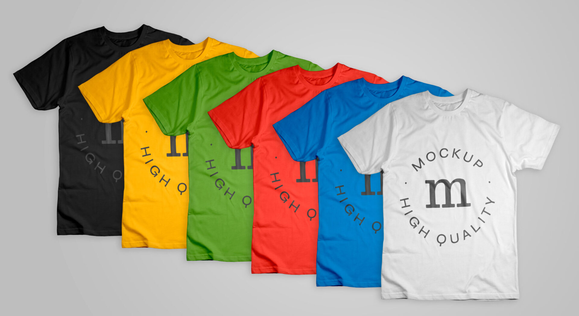 Six custom t-shirts in different colors — black, gold, green, red, blue, and white — fanned out to show the variety of shirt color options available for screen printing, illustrating how shirt color choice affects how many ink colors you need in your design