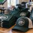 Matching custom club team gear including printed shirts, a hoodie, an embroidered trucker cap, and a drawstring bag with one team logo at an Austin shop